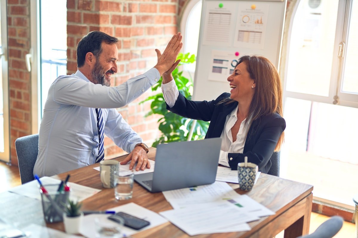 A speaker and organiser preparing a brief together